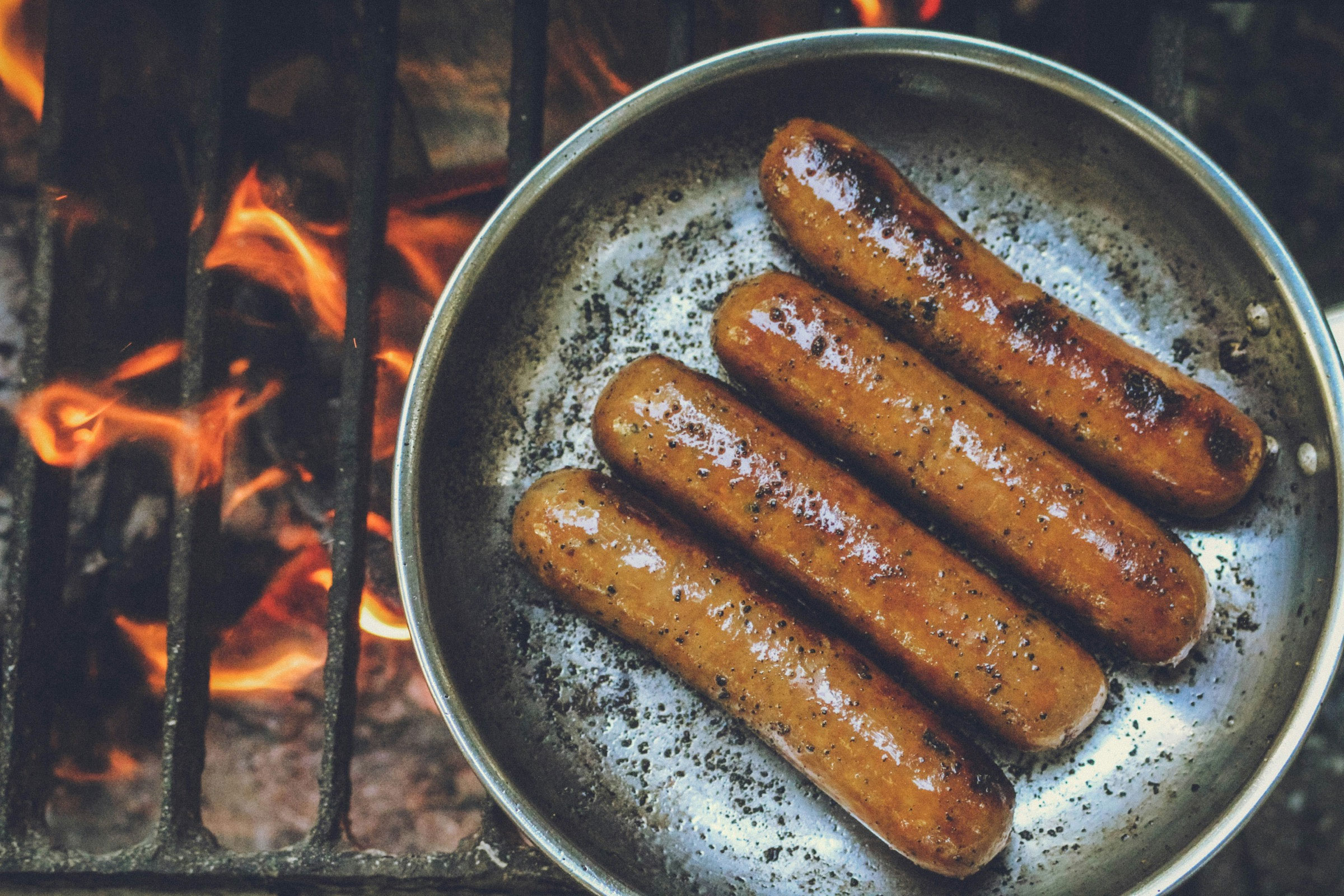 Scarfo's sausages cooking over an open fire